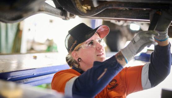 Young woman fixing truck